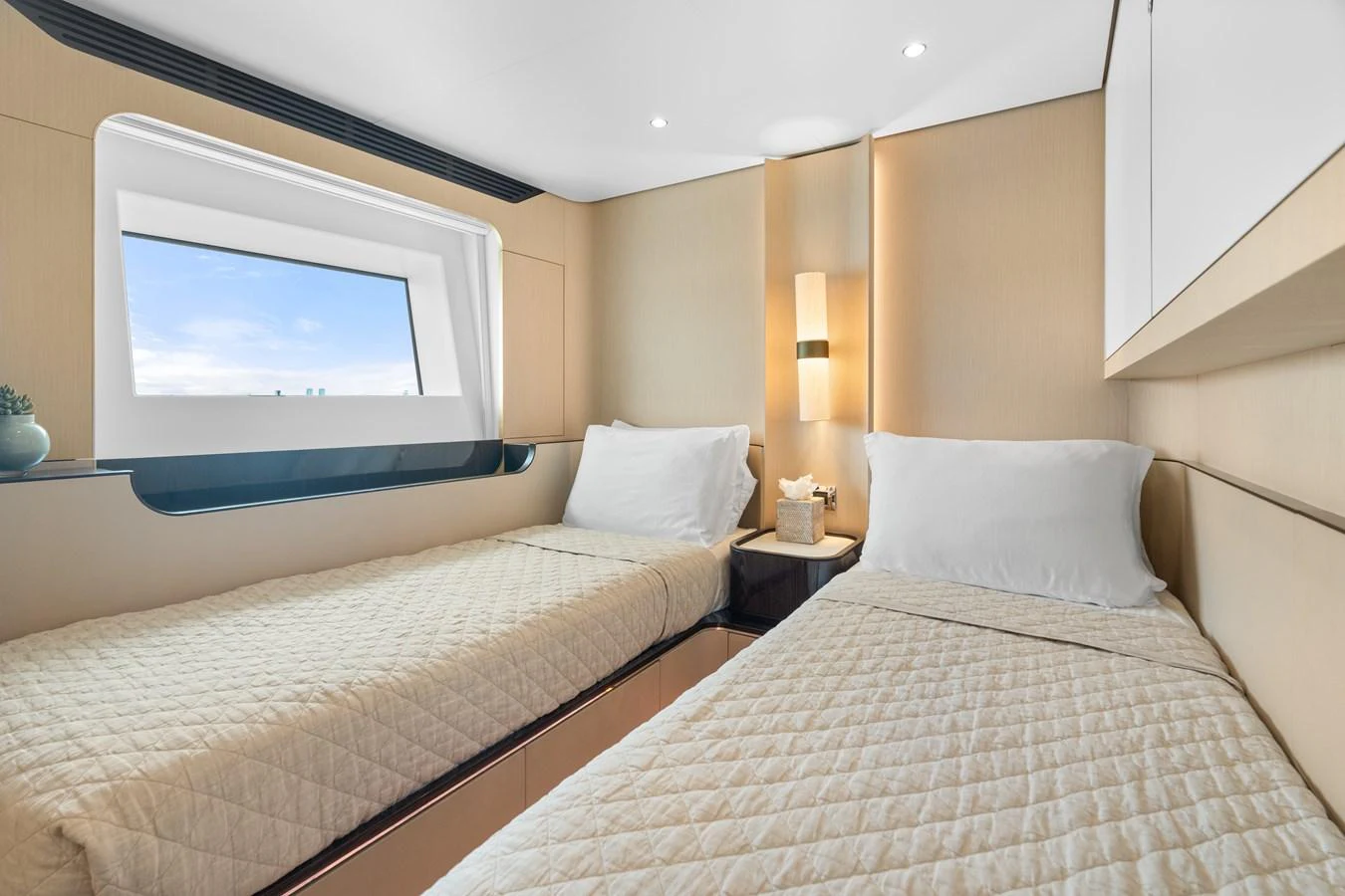 The twin stateroom offers a cozy and inviting space with two single beds and a large window for natural light. aboard AZIMUT GRANDE 32/23 Yacht for Sale