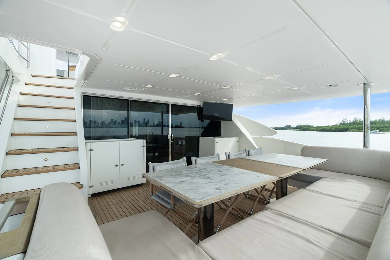 The aft deck features a spacious seating area with a dining table, perfect for alfresco dining and relaxation. aboard AZIMUT GRANDE 32/23 Yacht for Sale