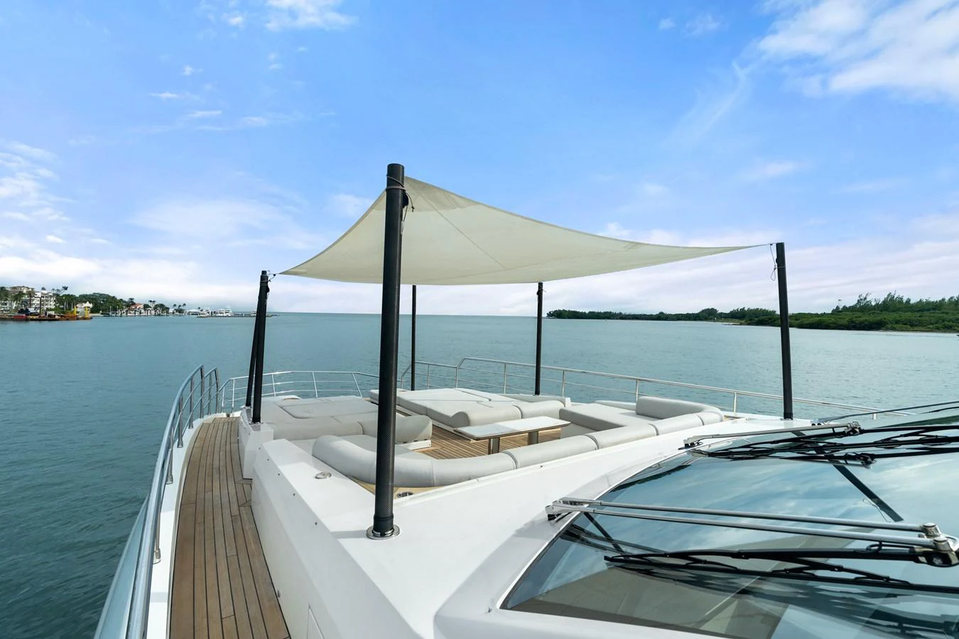 The yacht's flybridge offers a spacious lounging area with a sunshade, perfect for relaxation and enjoying the view. aboard AZIMUT GRANDE 32/23 Yacht for Sale