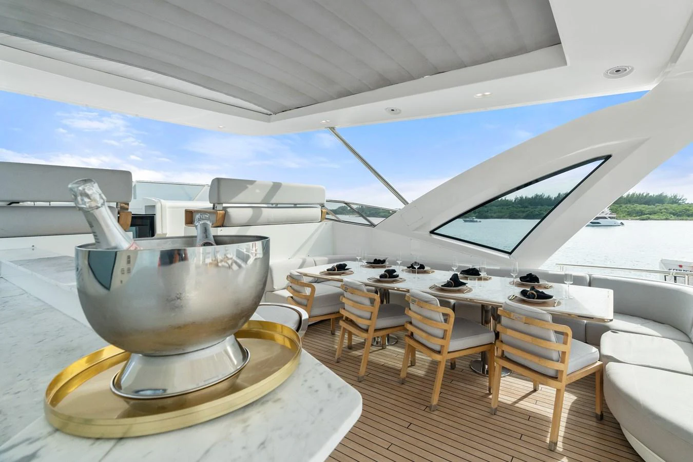 The aft deck features a luxurious dining area with a stunning view of the water. aboard AZIMUT GRANDE 32/23 Yacht for Sale