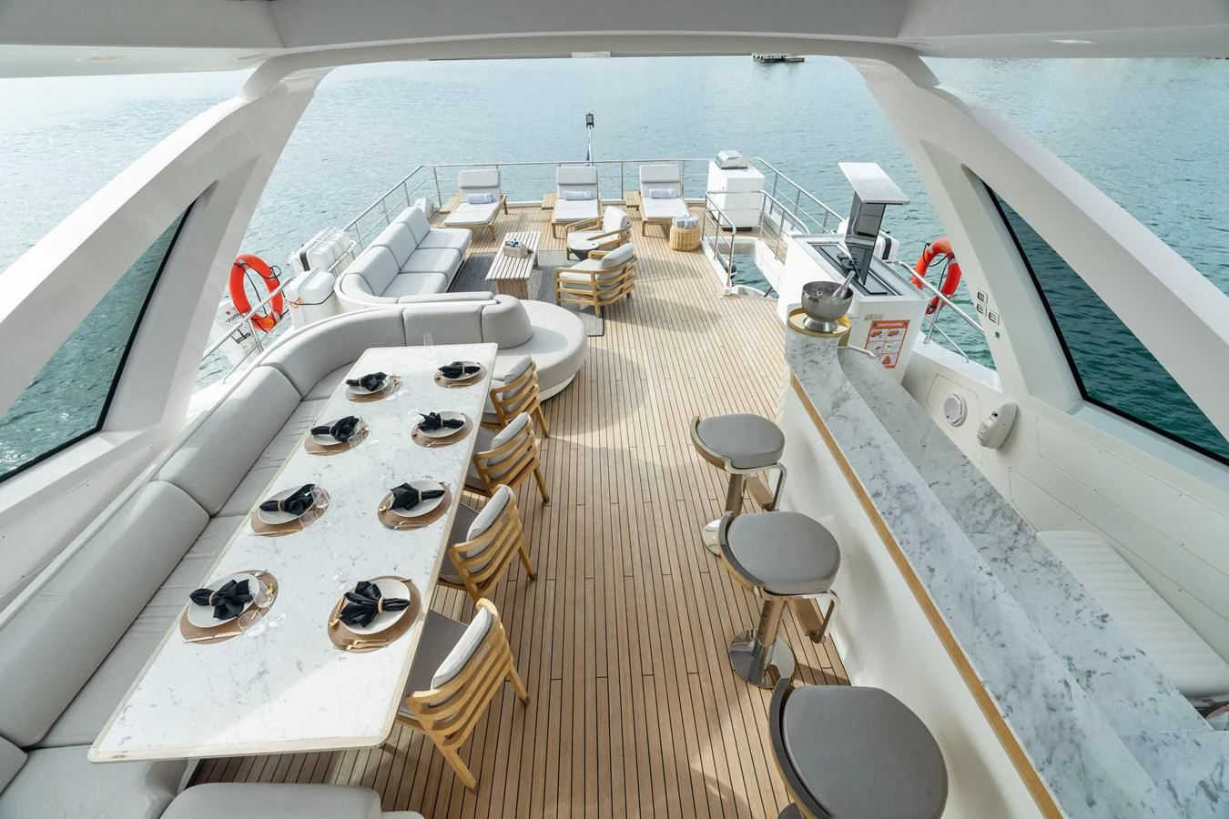 The flybridge offers an inviting space with ample seating, a dining area, and a bar, perfect for entertaining while enjoying panoramic views. aboard AZIMUT GRANDE 32/23 Yacht for Sale