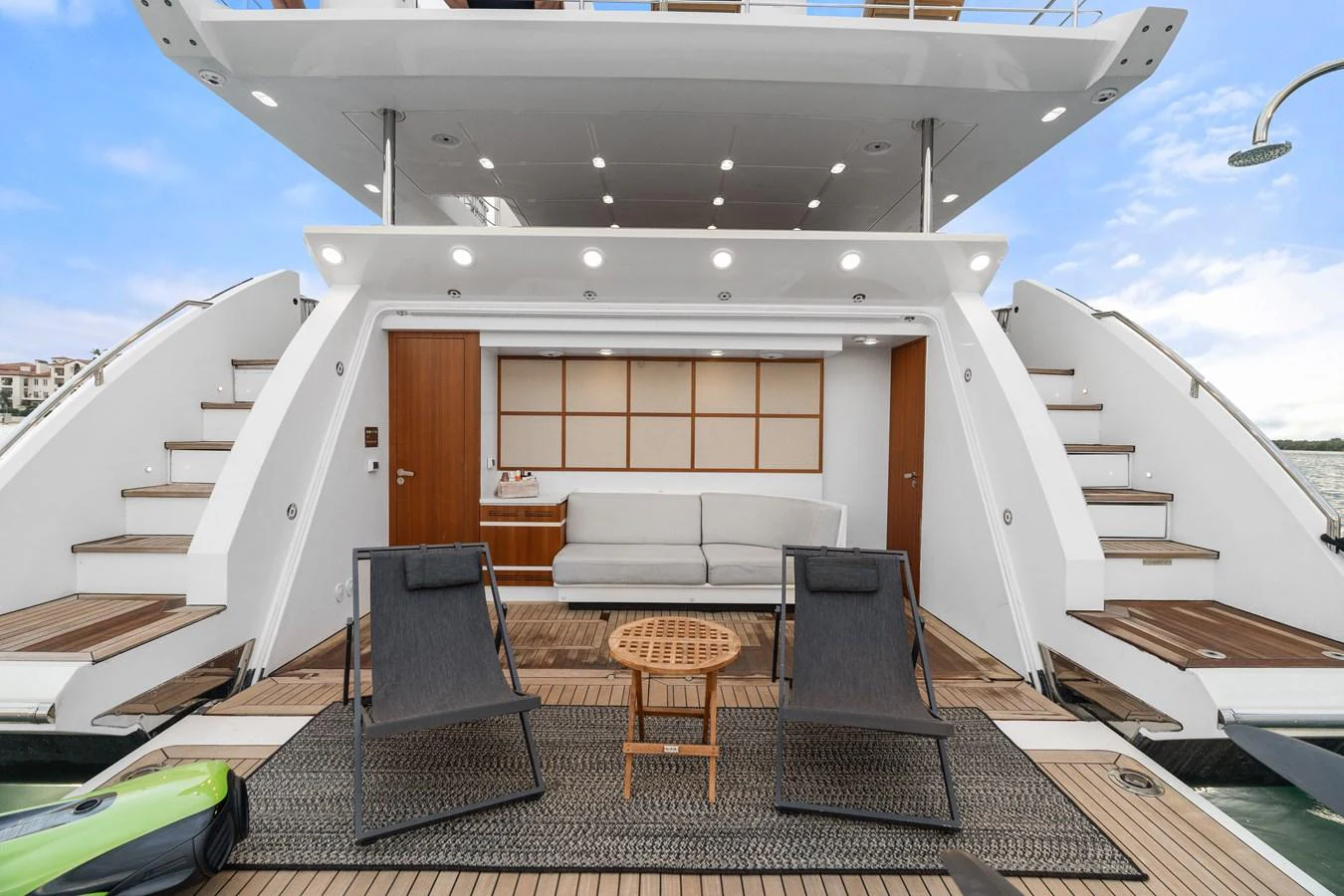 The yacht's aft deck features a stylish seating area with modern furniture and elegant design. aboard AZIMUT GRANDE 32/23 Yacht for Sale