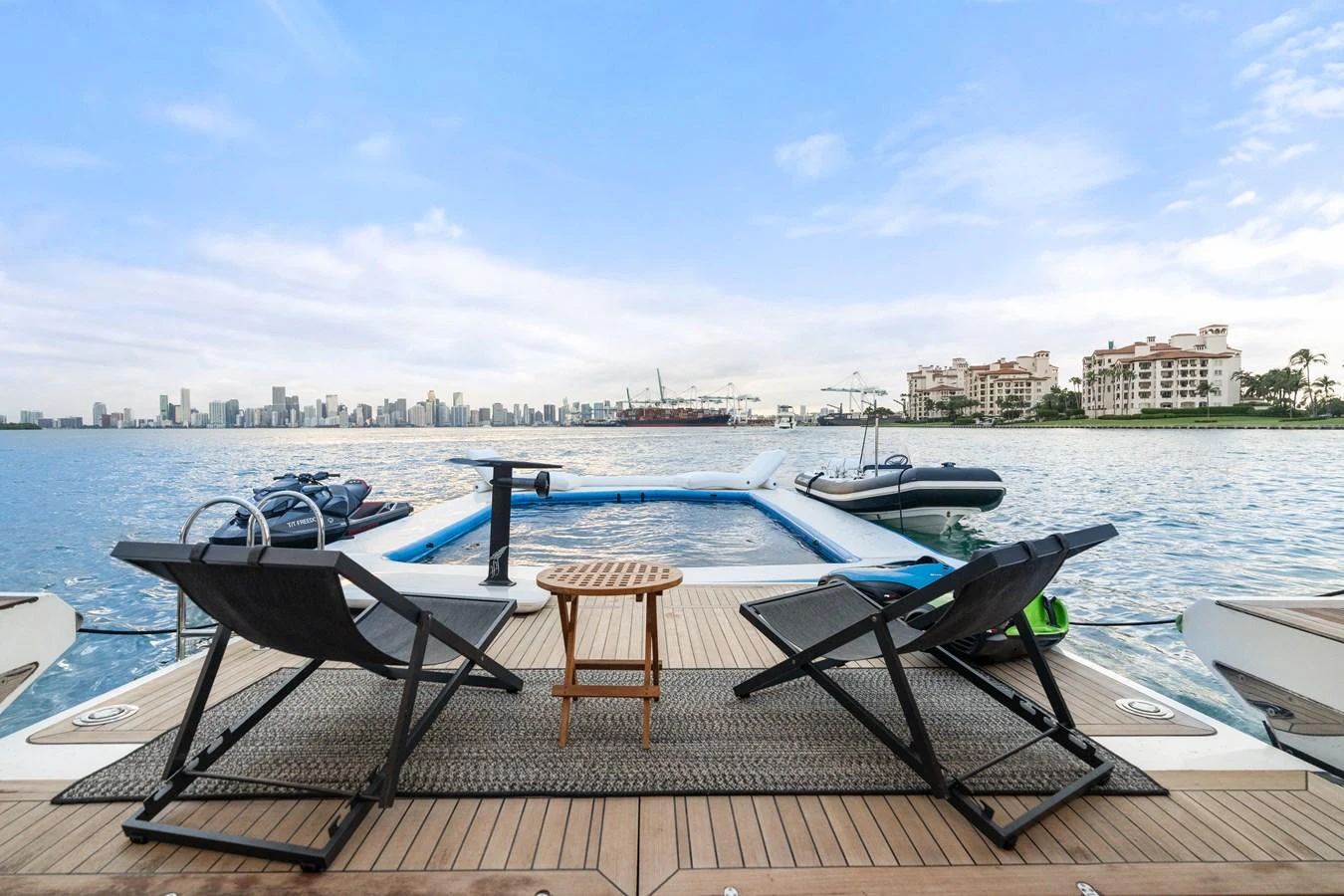 The aft deck features a luxurious lounging area with stunning views of the water and city skyline. aboard AZIMUT GRANDE 32/23 Yacht for Sale