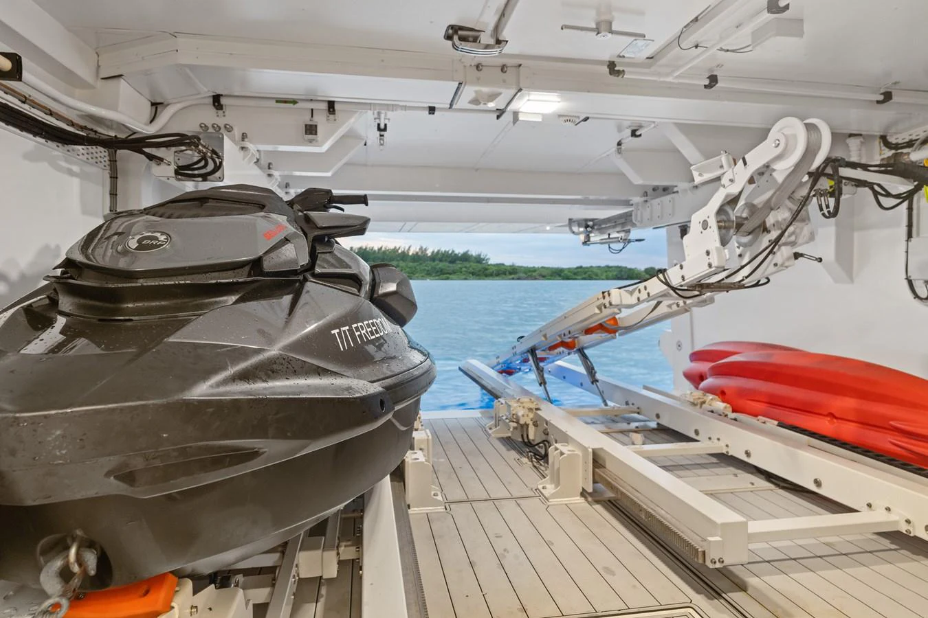 The yacht's garage houses a sleek jet ski and vibrant kayaks, ready for adventure. aboard AZIMUT GRANDE 32/23 Yacht for Sale