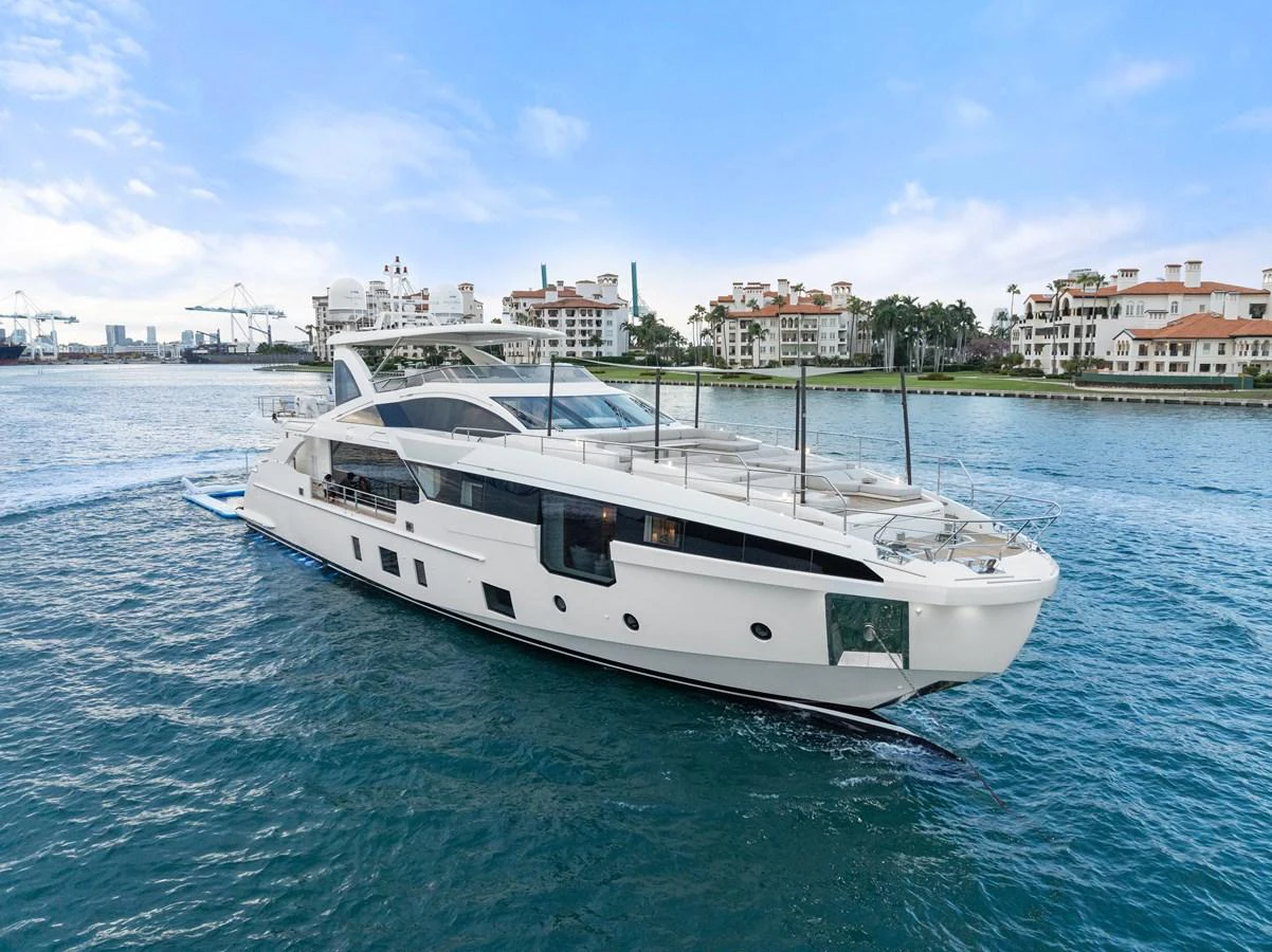 A sleek and modern yacht cruising along a picturesque waterfront. aboard AZIMUT GRANDE 32/23 Yacht for Sale