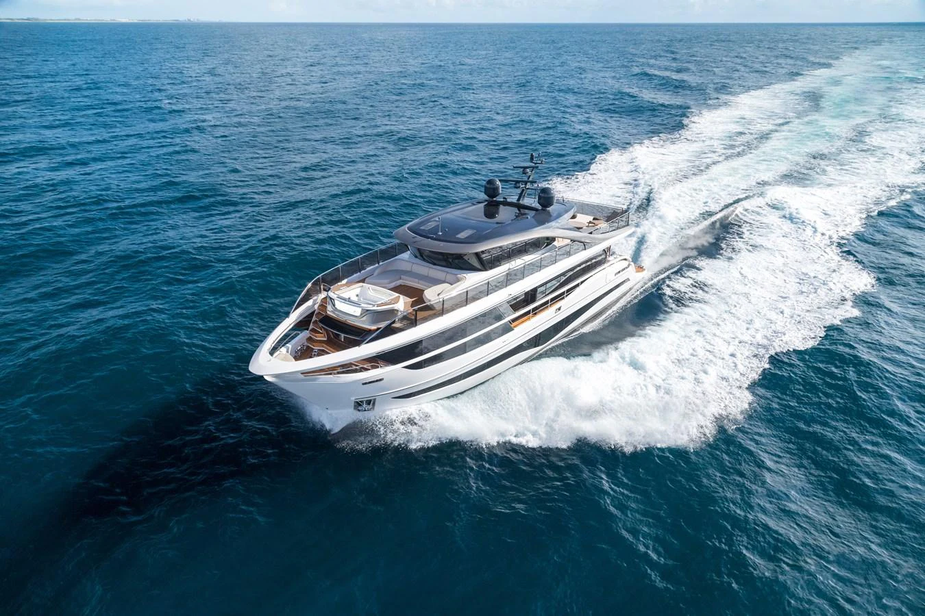 A sleek and modern yacht cruises swiftly through the open sea. aboard PRINCESS X95 VISTA Yacht for Sale
