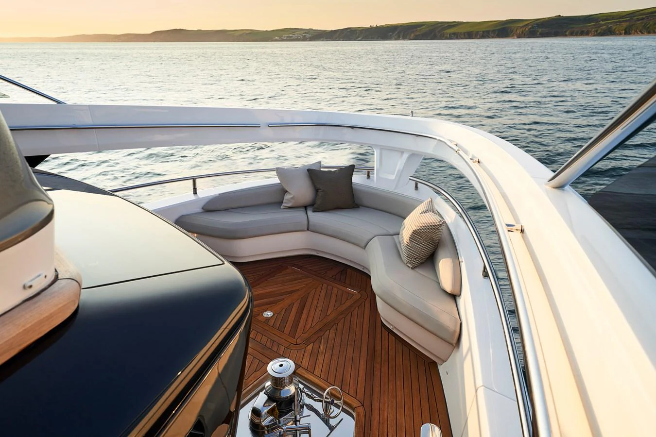 The yacht features a luxurious bow seating area with plush cushions and a stunning view of the water. aboard PRINCESS X95 VISTA Yacht for Sale
