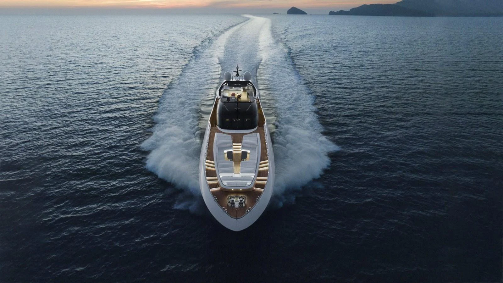 A sleek yacht cruises swiftly through open waters, leaving a trail of white foam behind. aboard REBELLIOUS Yacht for Sale