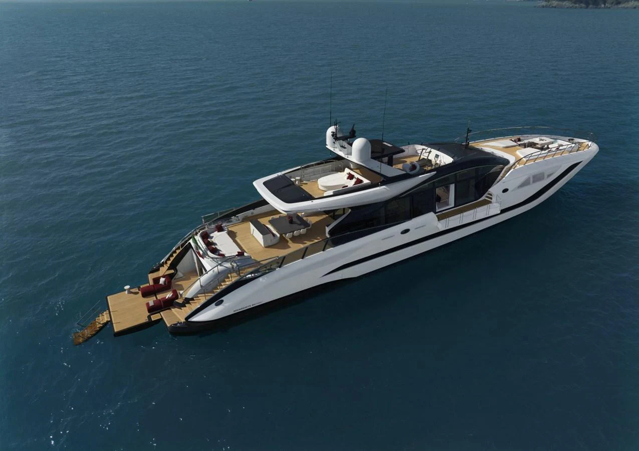 A sleek and modern yacht cruising on calm waters, showcasing its luxurious design and spacious deck areas. aboard REBELLIOUS Yacht for Sale