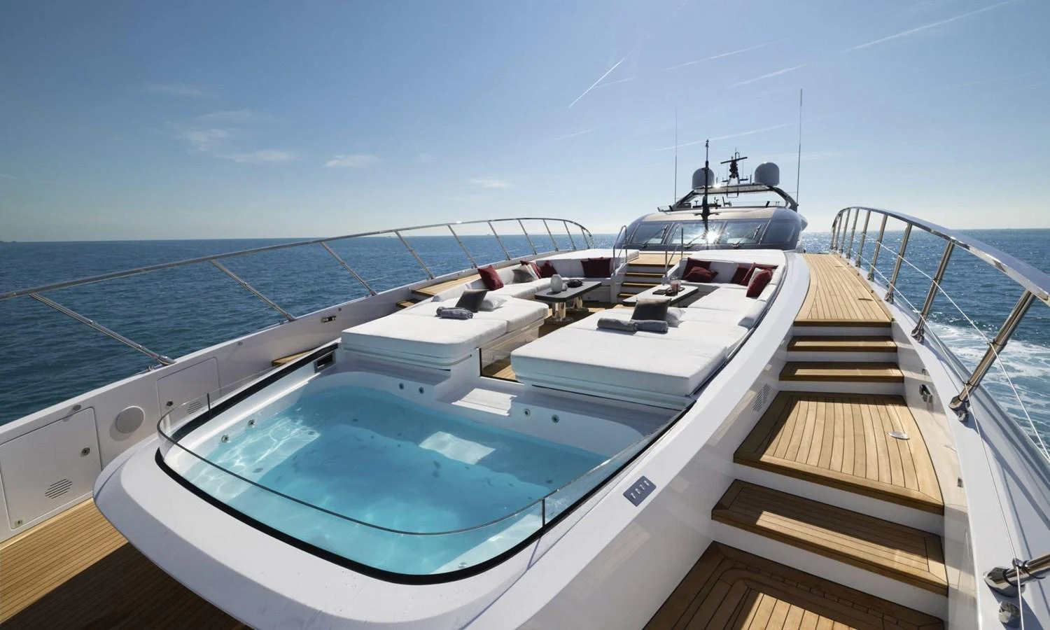 The sundeck features luxurious sun loungers and a jacuzzi, offering a perfect spot for relaxation with stunning ocean views. aboard REBELLIOUS Yacht for Sale