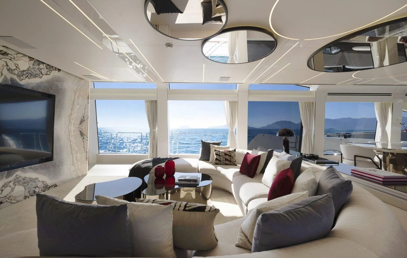 The salon features luxurious seating with panoramic views of the sea. aboard REBELLIOUS Yacht for Sale