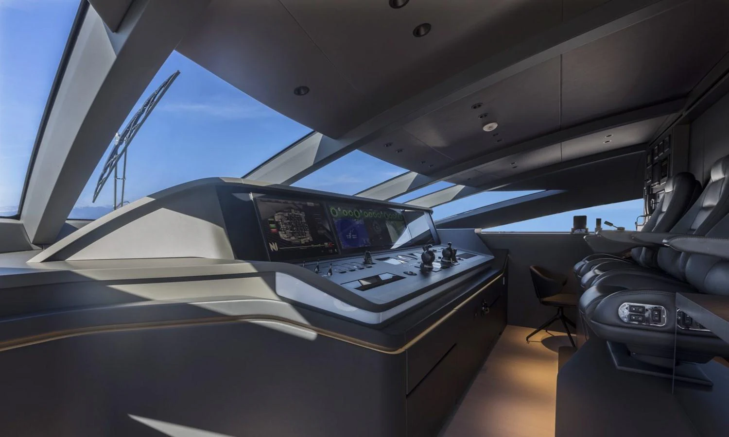 The helm station features state-of-the-art navigation equipment and luxurious seating. aboard REBELLIOUS Yacht for Sale