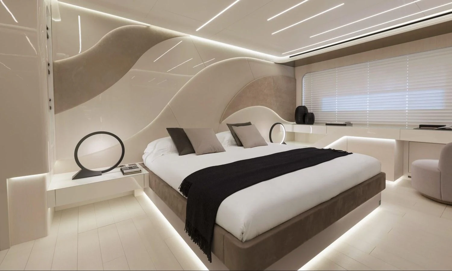 The master stateroom features a luxurious bed with modern design elements and ambient lighting. aboard REBELLIOUS Yacht for Sale