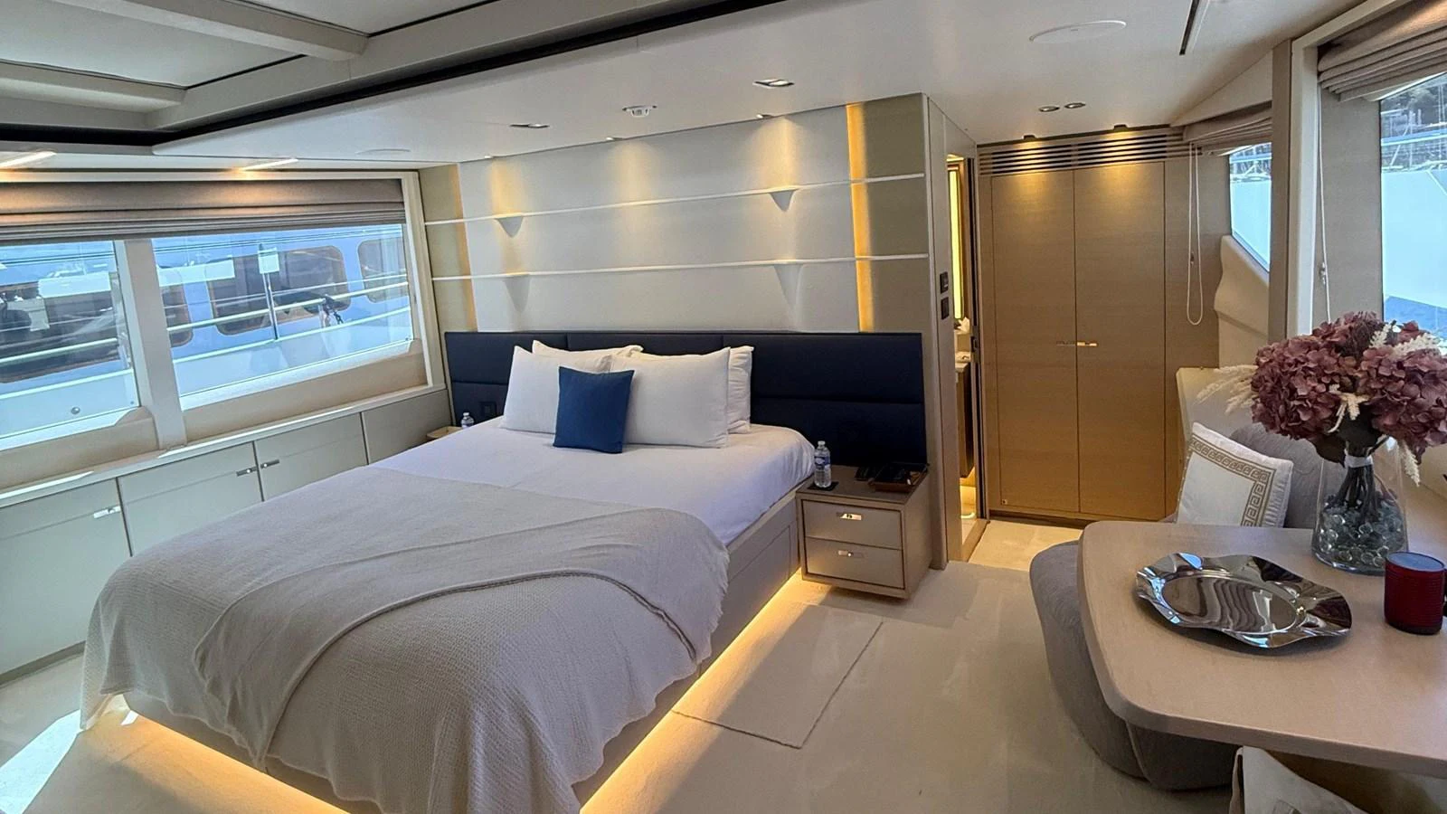 The master stateroom features a luxurious bed with elegant decor and ample natural light. aboard ADROMELIA Yacht for Sale
