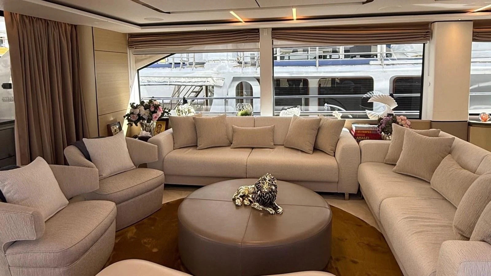 The salon features plush seating and elegant decor, offering a comfortable and stylish space for relaxation. aboard ADROMELIA Yacht for Sale