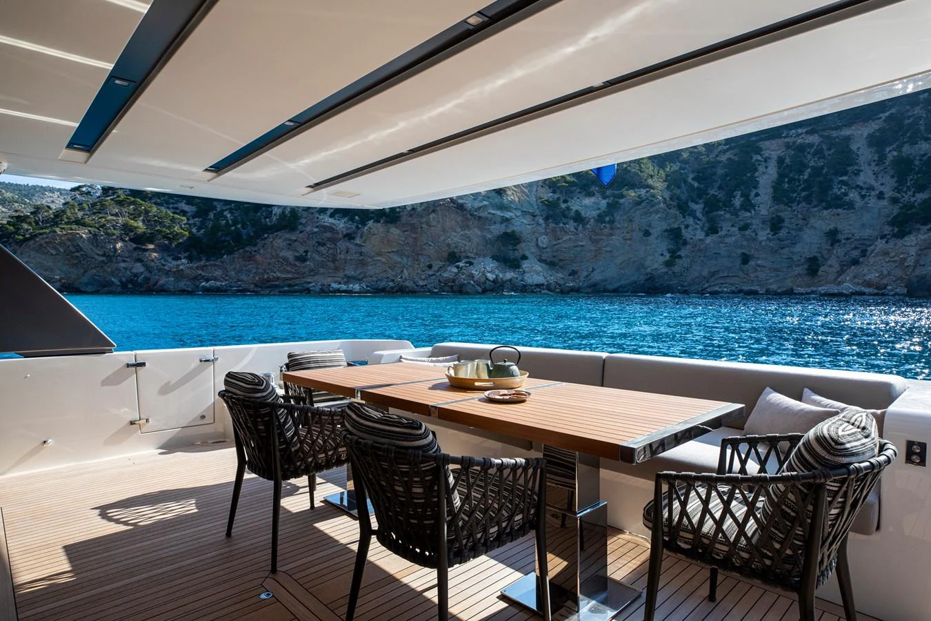 The aft deck offers a luxurious dining area with stunning ocean views. aboard SEVEN Yacht for Sale