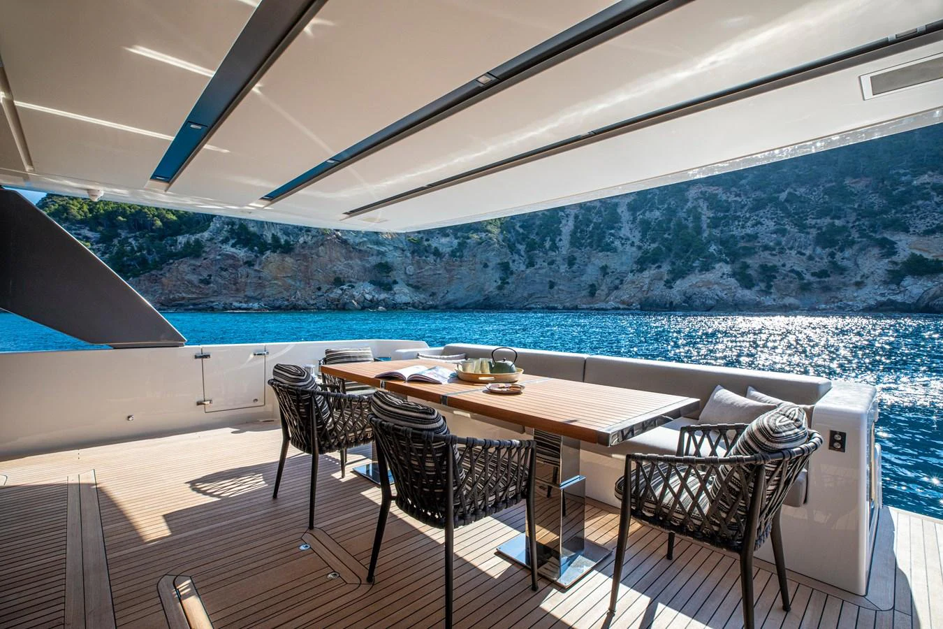The aft deck features an elegant dining area with a stunning view of the surrounding waters. aboard SEVEN Yacht for Sale