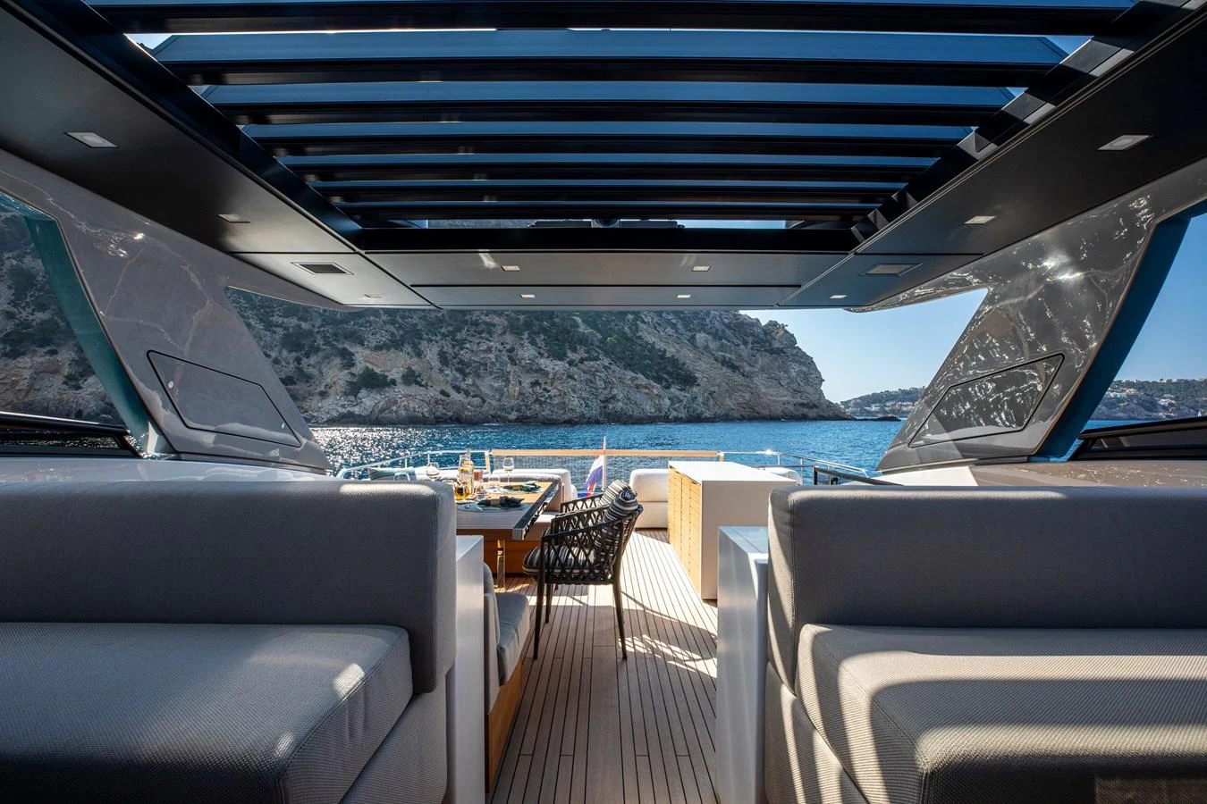 The aft deck offers a luxurious seating area with stunning views of the surrounding waters. aboard SEVEN Yacht for Sale