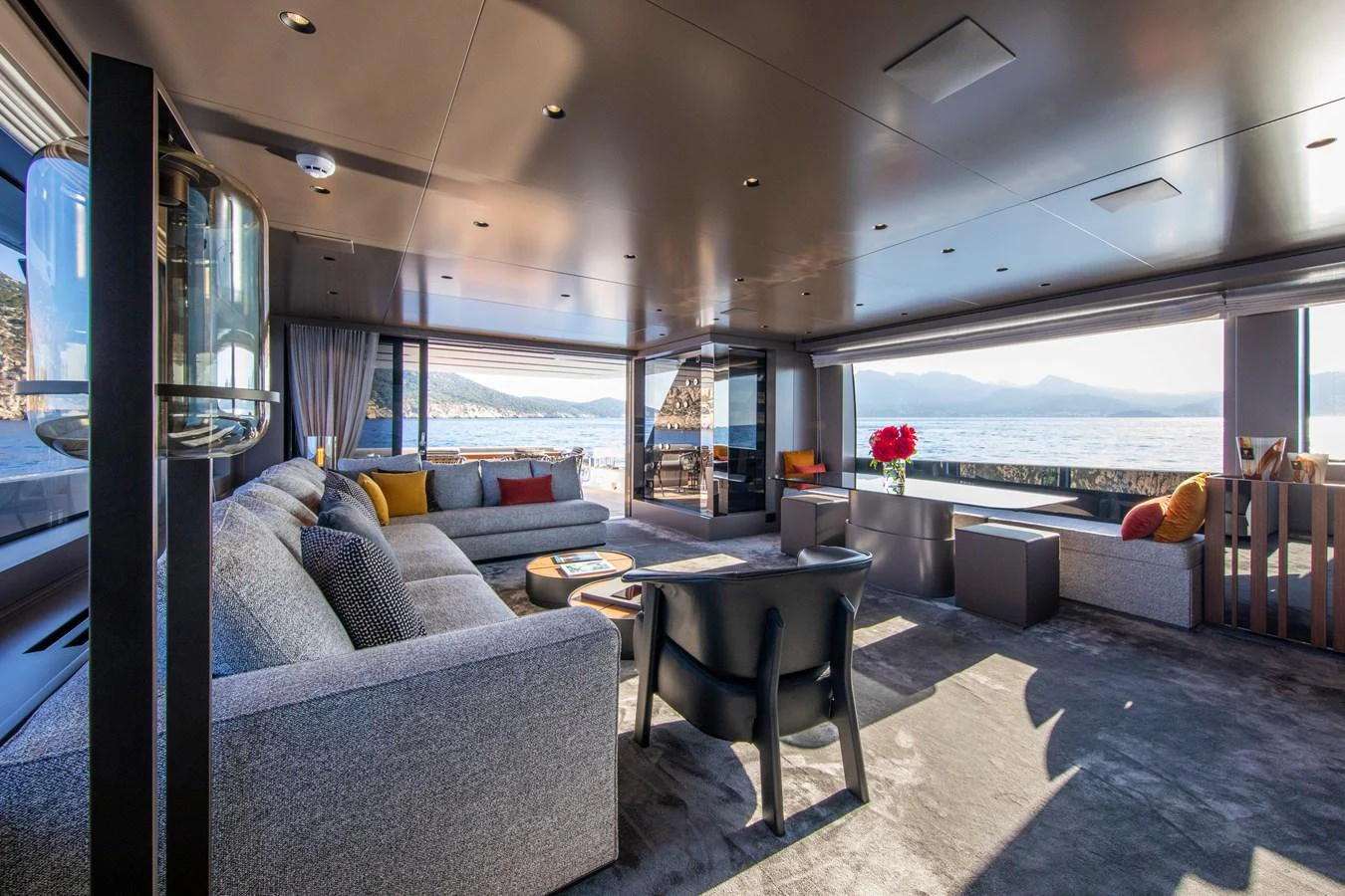 The salon offers a spacious and luxurious seating area with panoramic views of the sea. aboard SEVEN Yacht for Sale