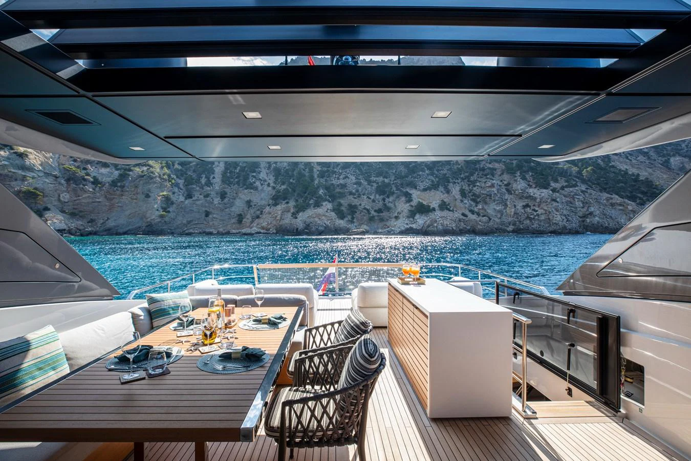 The aft deck offers a luxurious dining area with stunning views of the surrounding waters. aboard SEVEN Yacht for Sale