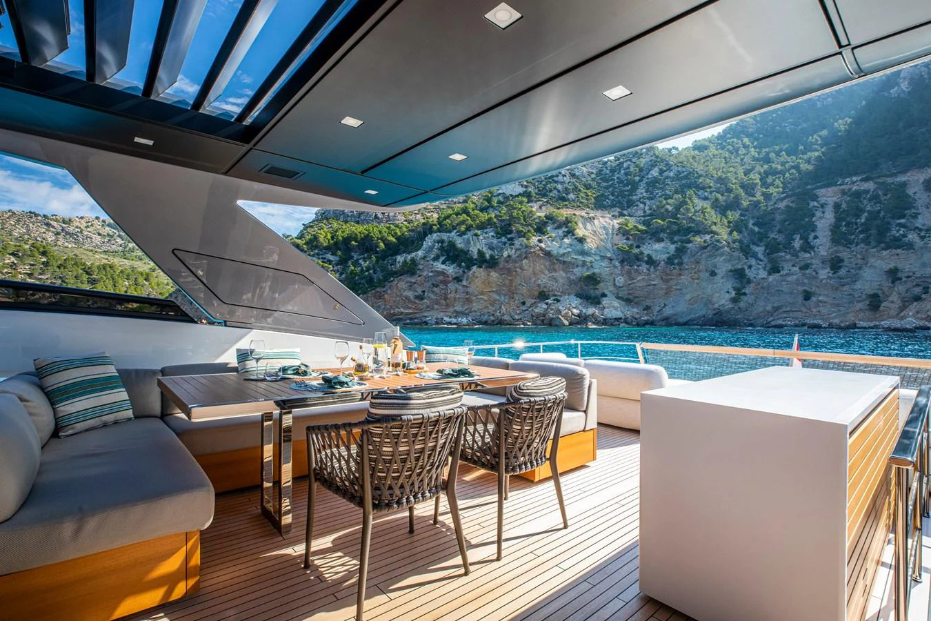 The aft deck offers a luxurious outdoor dining area with stunning views of the surrounding landscape. aboard SEVEN Yacht for Sale