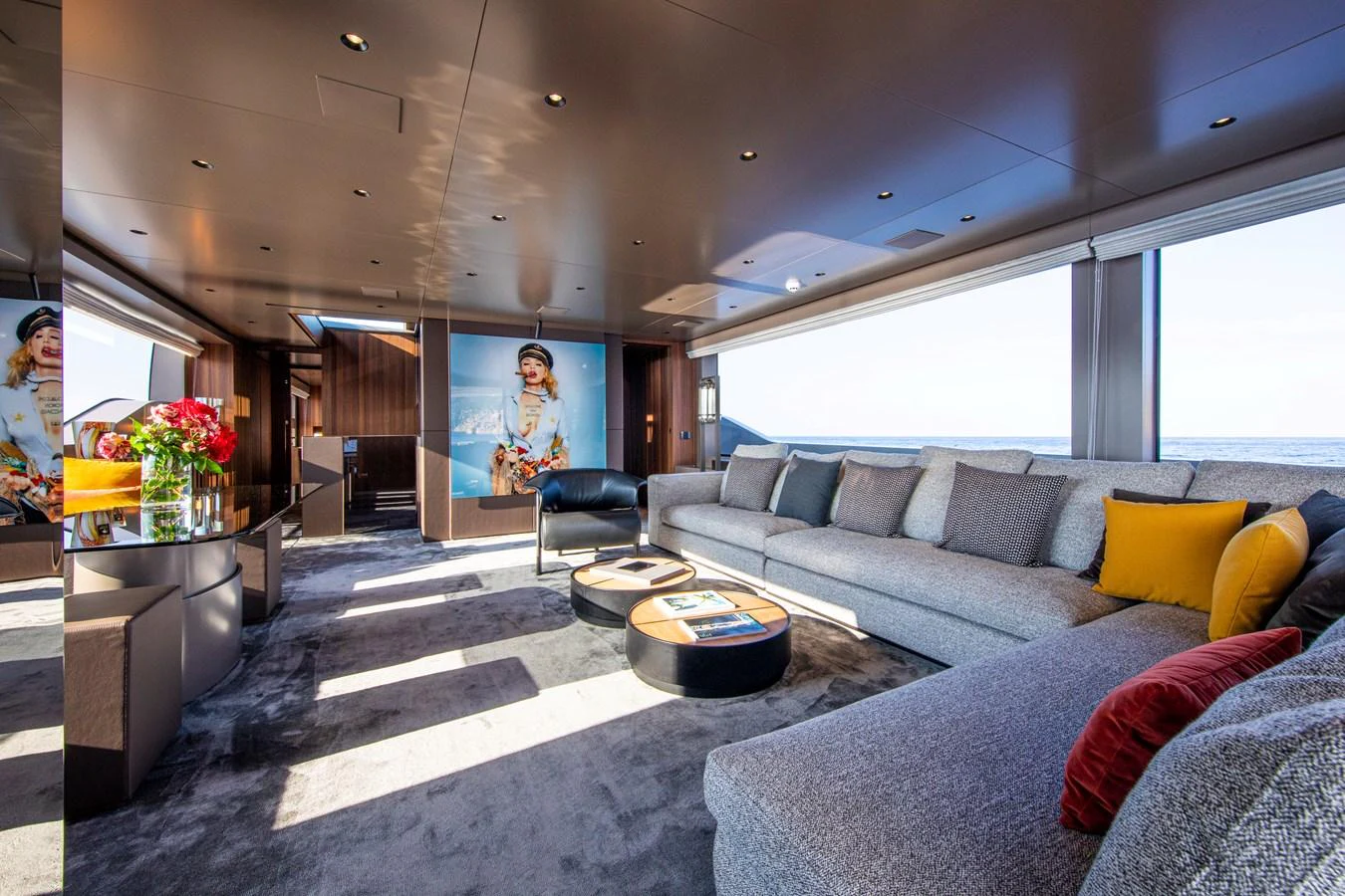 The salon features a spacious seating area with modern decor and large windows offering panoramic views. aboard SEVEN Yacht for Sale