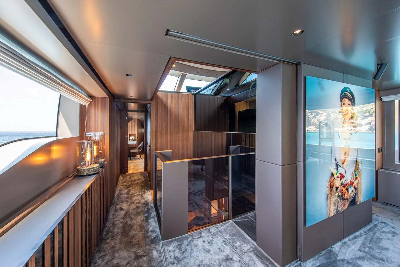 The yacht's interior features a modern hallway with sleek wooden accents and ample natural light. aboard SEVEN Yacht for Sale