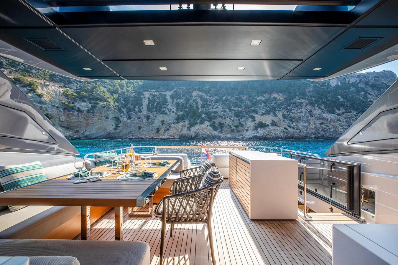The aft deck offers a luxurious dining area with stunning views of the surrounding landscape. aboard SEVEN Yacht for Sale