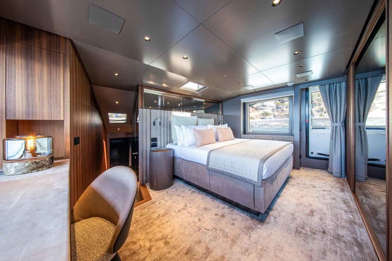 The master stateroom features a luxurious bed, elegant furnishings, and ample natural light. aboard SEVEN Yacht for Sale