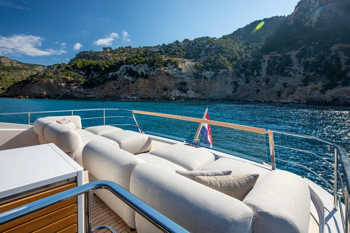 The sundeck offers plush seating with stunning views of the surrounding waters and cliffs. aboard SEVEN Yacht for Sale