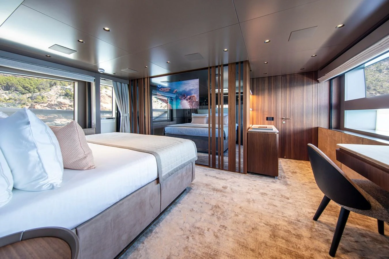 The master stateroom features a spacious layout with luxurious bedding and modern decor. aboard SEVEN Yacht for Sale