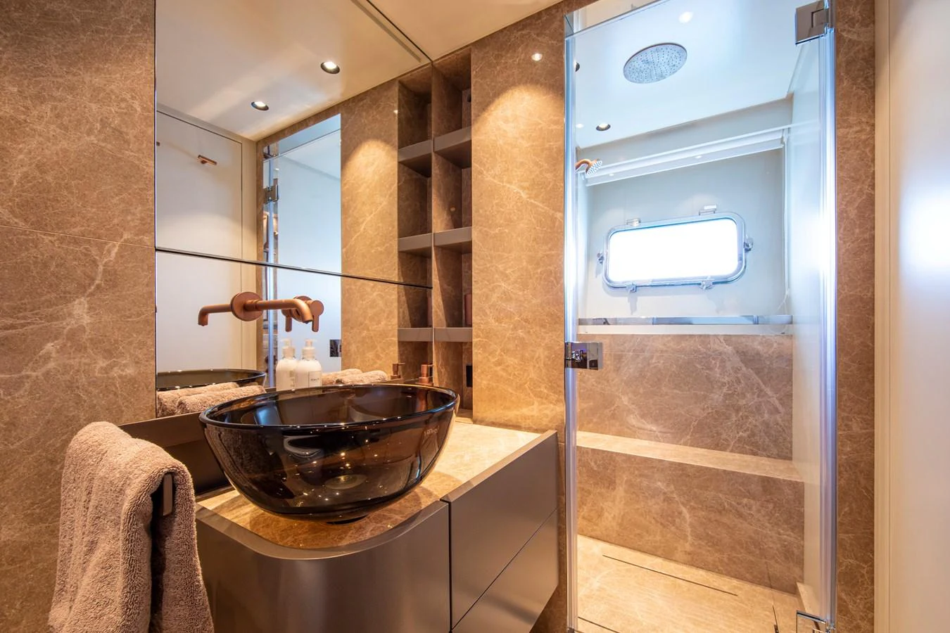 The yacht's bathroom features elegant marble surfaces and modern fixtures. aboard SEVEN Yacht for Sale