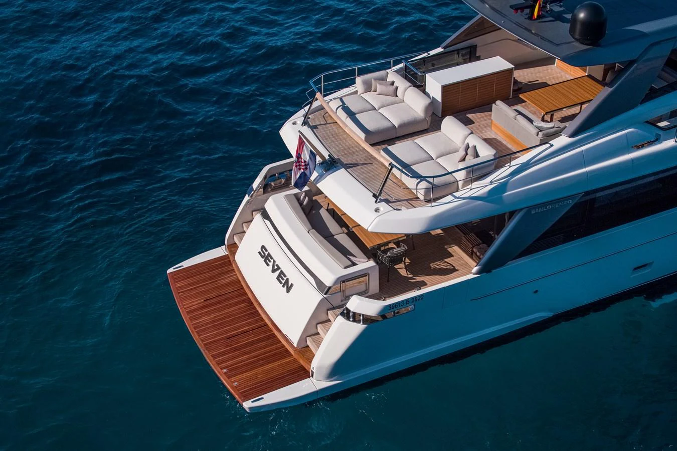 The yacht's aft deck features luxurious lounging areas and a swim platform, perfect for relaxation and water activities. aboard SEVEN Yacht for Sale