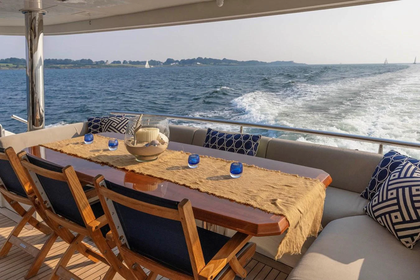 The aft deck features a stylish dining area with a beautiful view of the sea. aboard WRECKLESS Yacht for Sale