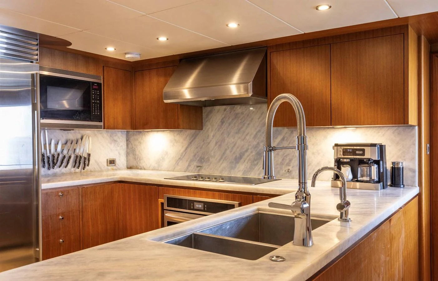 The galley features modern appliances and a sleek marble countertop, perfect for gourmet cooking at sea. aboard WRECKLESS Yacht for Sale