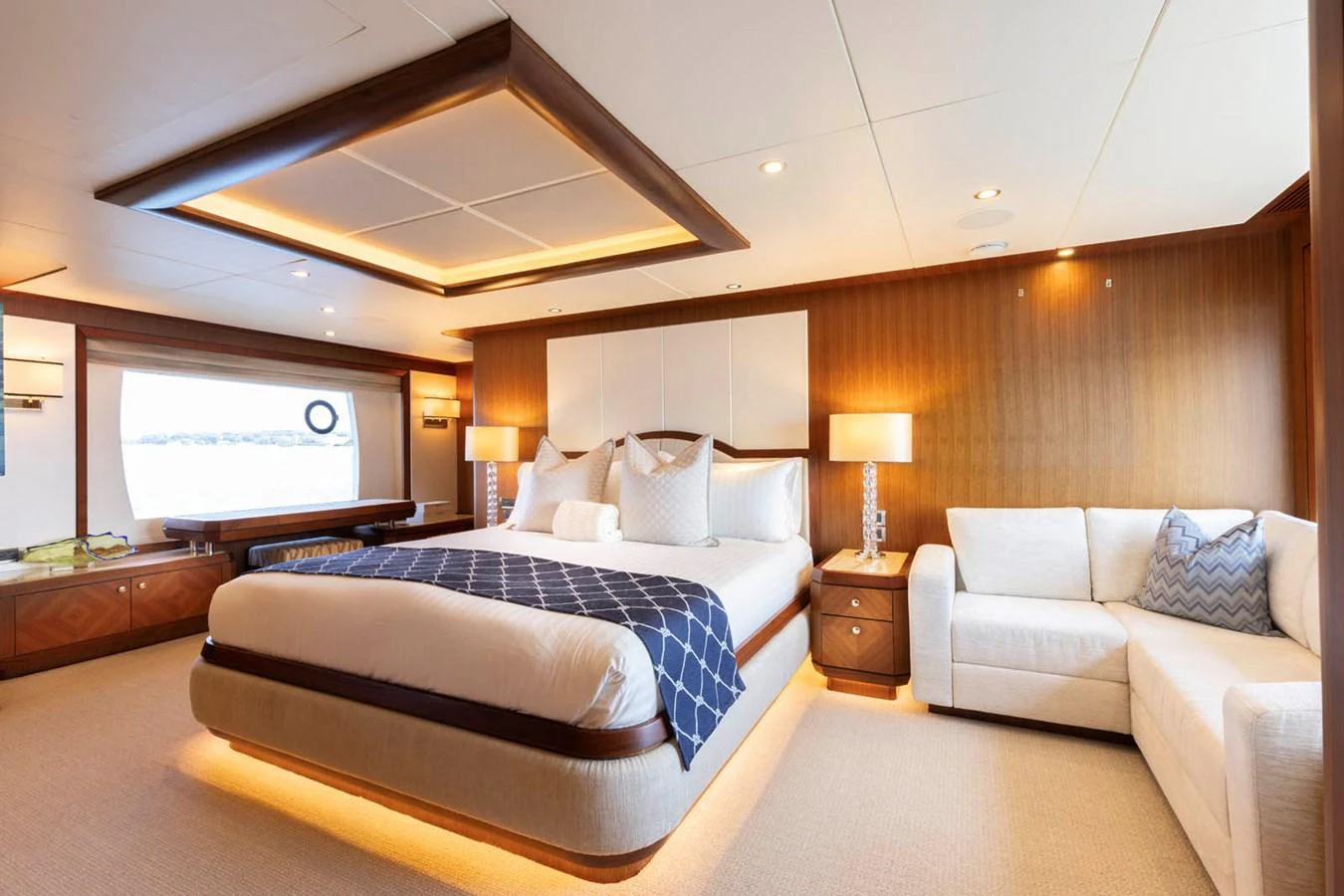 The master stateroom features a luxurious bed, elegant lighting, and a comfortable seating area. aboard WRECKLESS Yacht for Sale