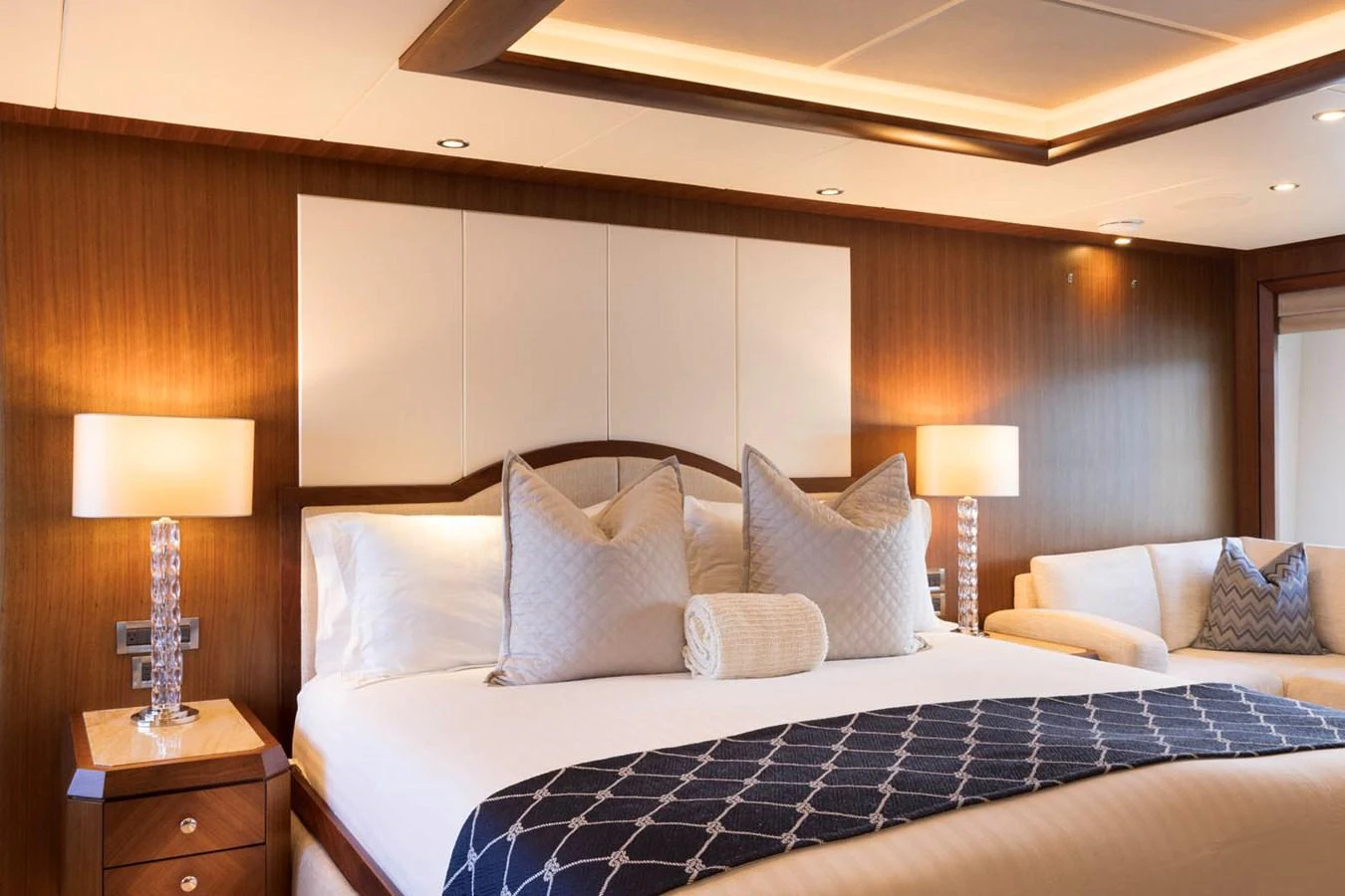 The master stateroom features a luxurious bed with elegant bedding and ambient lighting. aboard WRECKLESS Yacht for Sale