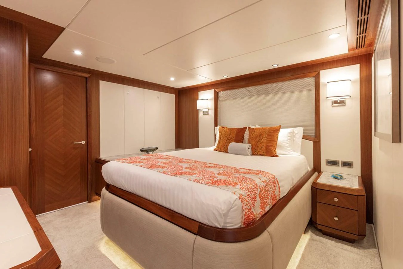 The master stateroom features a luxurious bed with elegant bedding and warm wood accents. aboard WRECKLESS Yacht for Sale