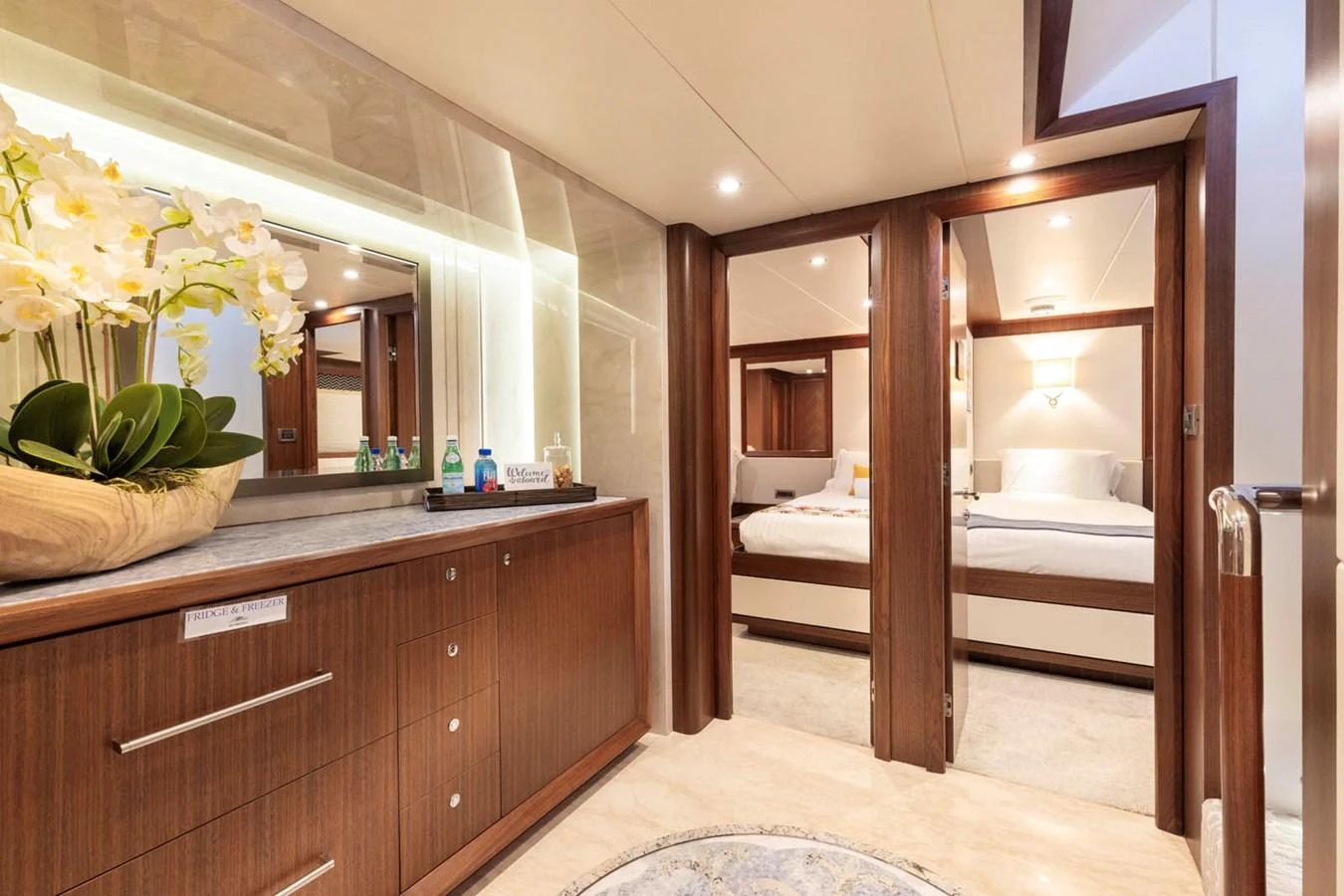 The image showcases a luxurious stateroom with elegant wood finishes and a comfortable bed. aboard WRECKLESS Yacht for Sale