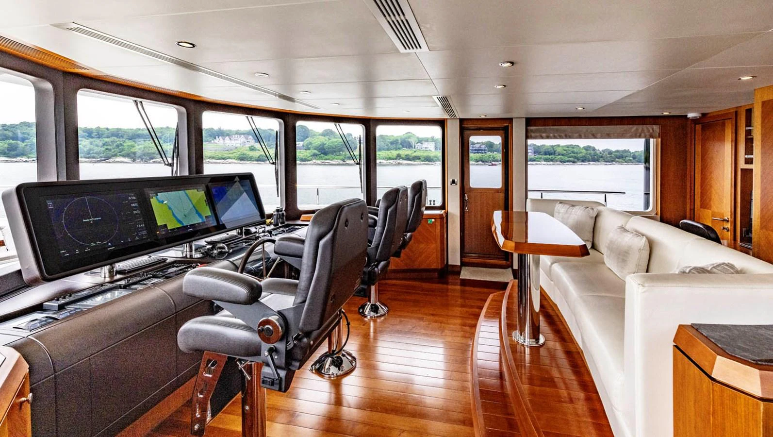 The helm area features state-of-the-art navigation equipment and a comfortable seating arrangement with panoramic views. aboard WRECKLESS Yacht for Sale