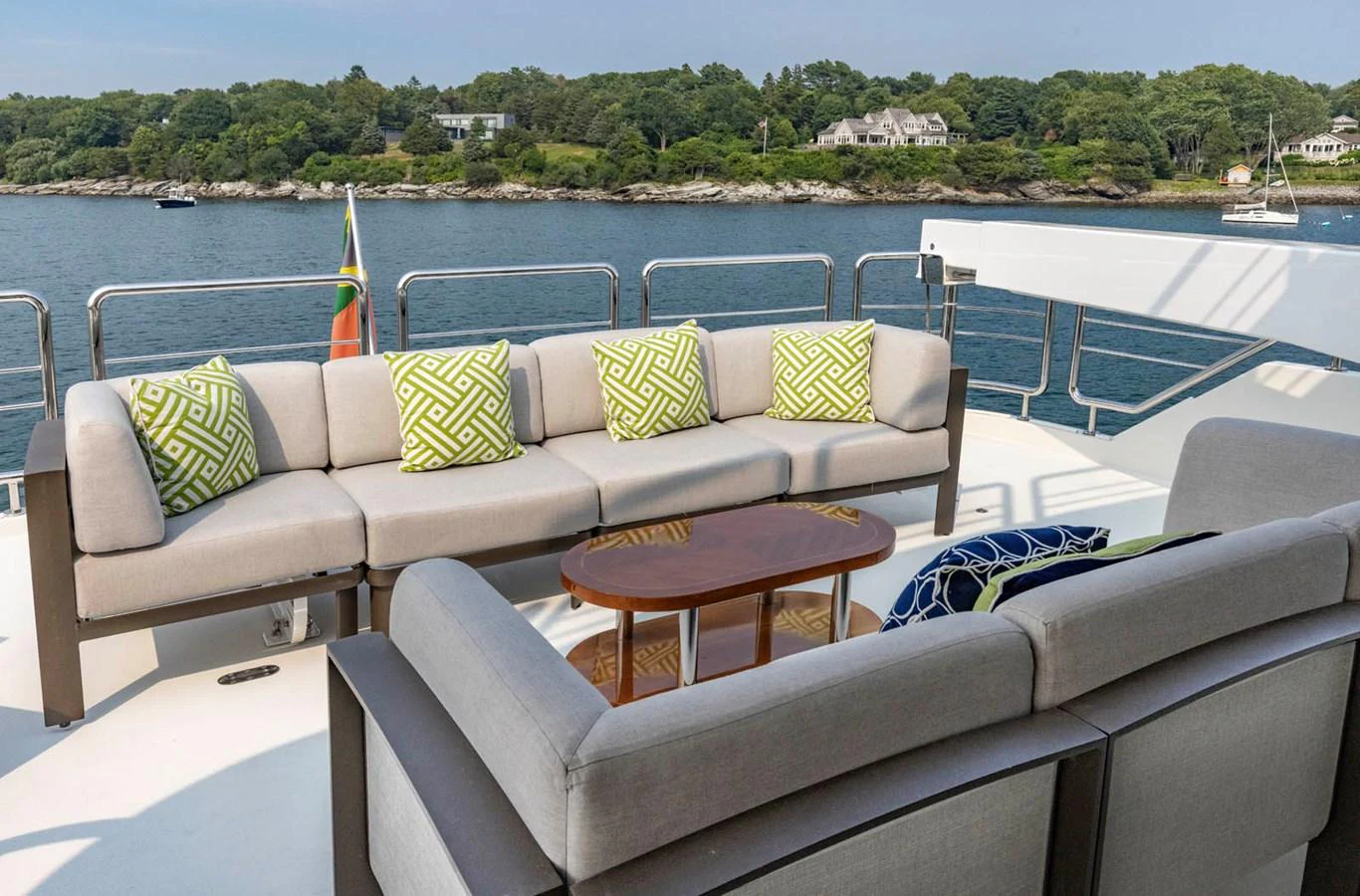 The aft deck features a comfortable seating area with plush cushions and a scenic view. aboard WRECKLESS Yacht for Sale