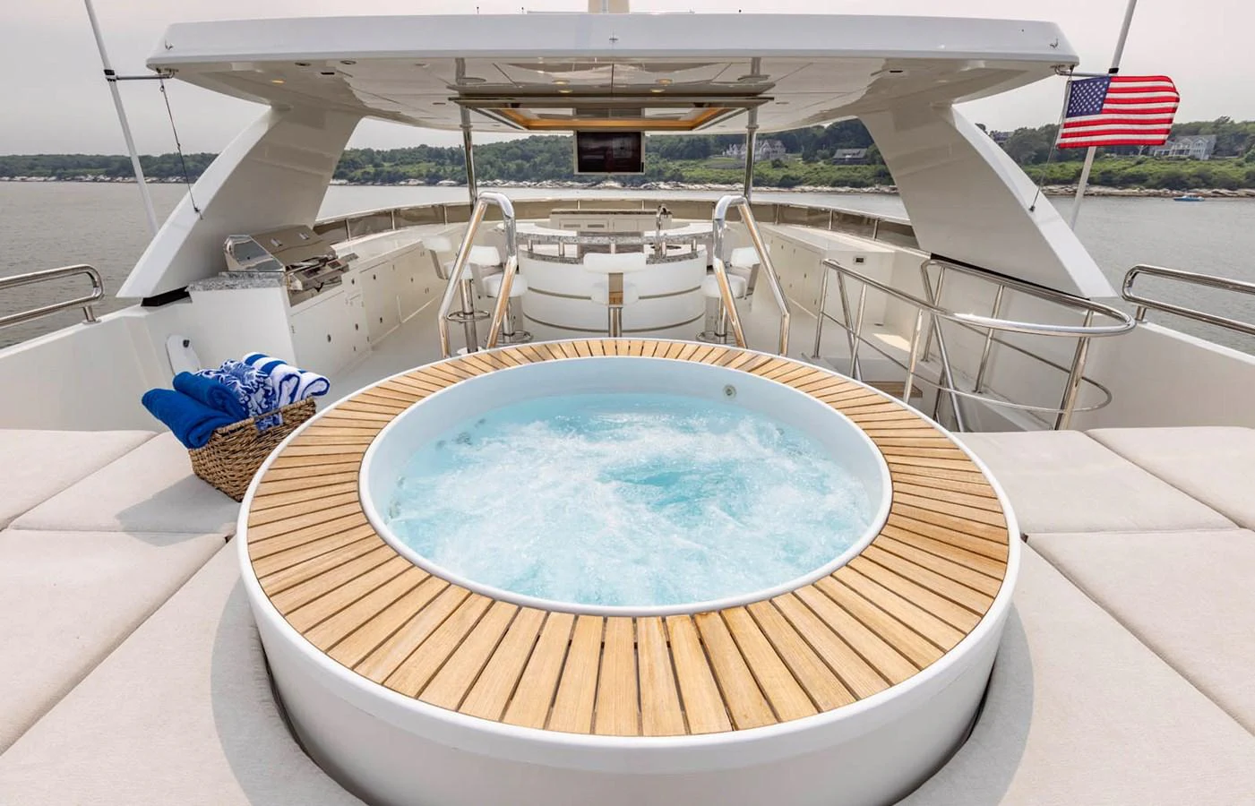 The sundeck features a luxurious jacuzzi surrounded by comfortable seating and a well-equipped bar area. aboard WRECKLESS Yacht for Sale