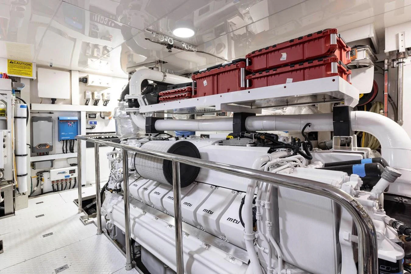 The image showcases a pristine engine room with advanced machinery and organized storage. aboard WRECKLESS Yacht for Sale