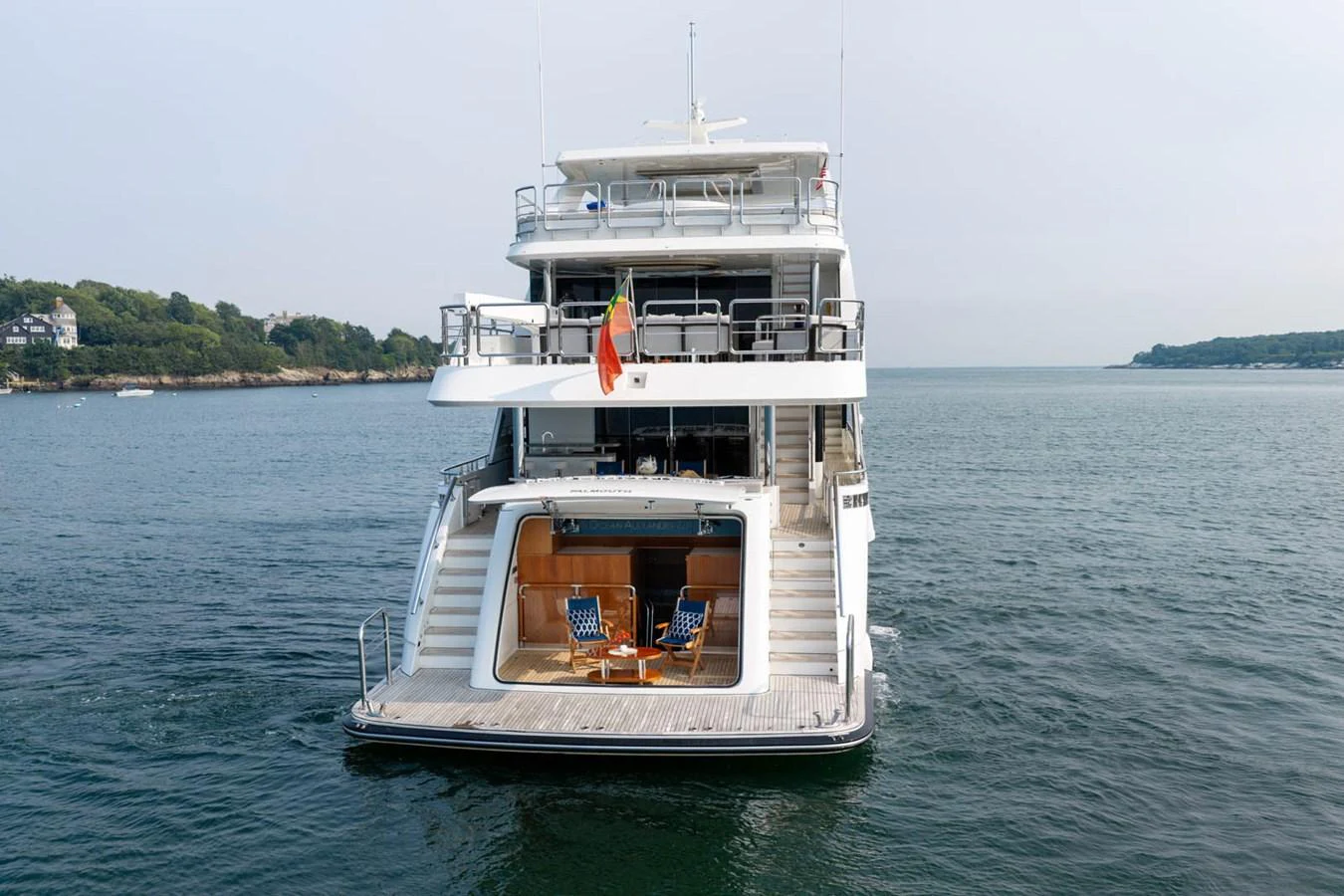 A luxurious yacht is anchored on calm waters, showcasing its multi-level decks and elegant design. aboard WRECKLESS Yacht for Sale