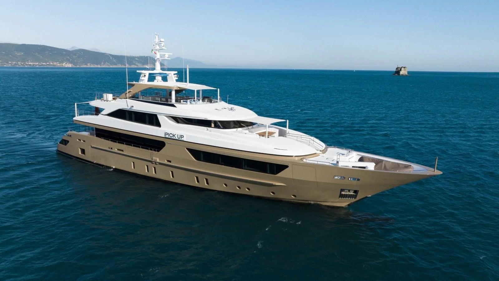 A luxurious yacht glides gracefully over the calm blue waters, showcasing its sleek design and spacious decks. aboard PICK UP Yacht for Sale