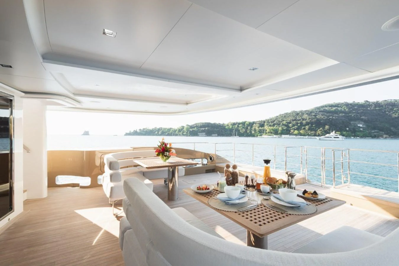 The aft deck offers a serene dining area with a stunning view of the water and surrounding landscape. aboard PICK UP Yacht for Sale