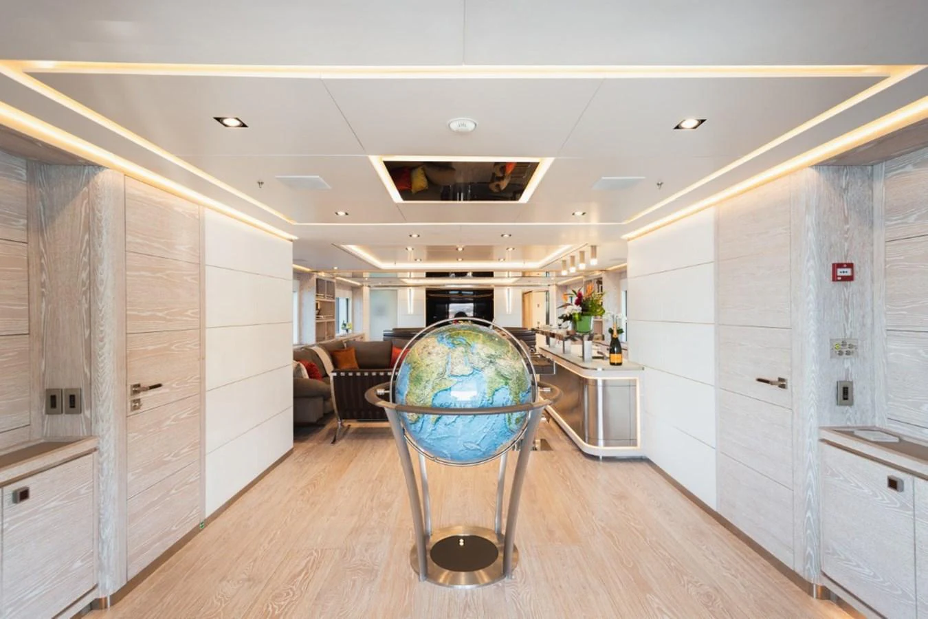 The yacht's interior features a spacious and modern design with a striking globe centerpiece. aboard PICK UP Yacht for Sale