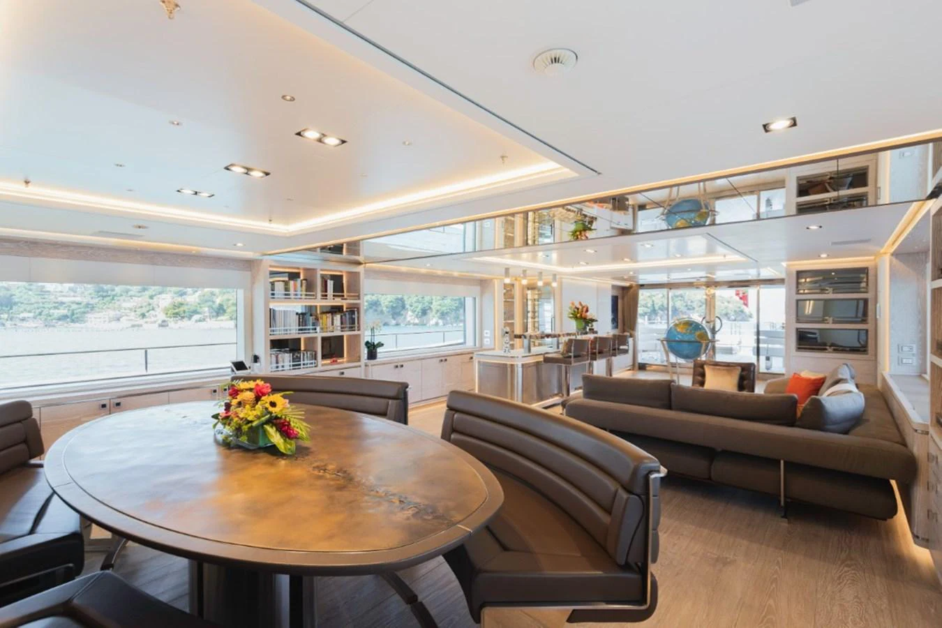 The yacht's salon features a spacious and elegantly designed seating area with a dining table and panoramic windows. aboard PICK UP Yacht for Sale