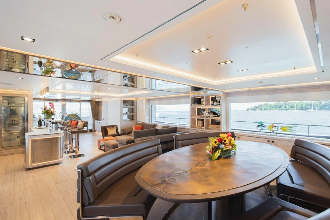 The spacious salon features a large dining table, comfortable seating, and expansive windows offering stunning views. aboard PICK UP Yacht for Sale