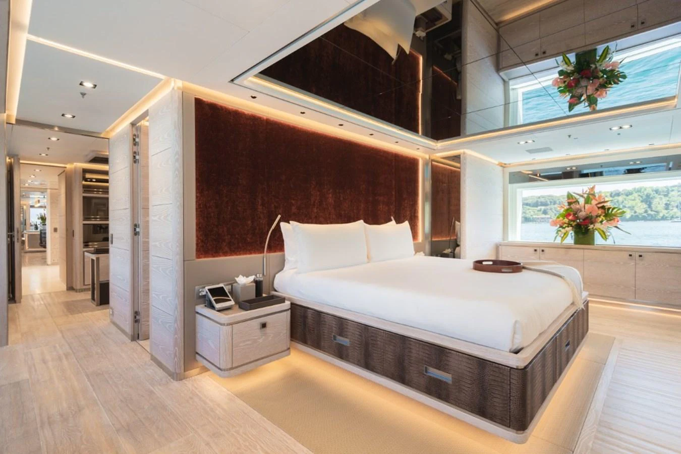 The master stateroom features a luxurious bed, elegant decor, and ample natural light. aboard PICK UP Yacht for Sale